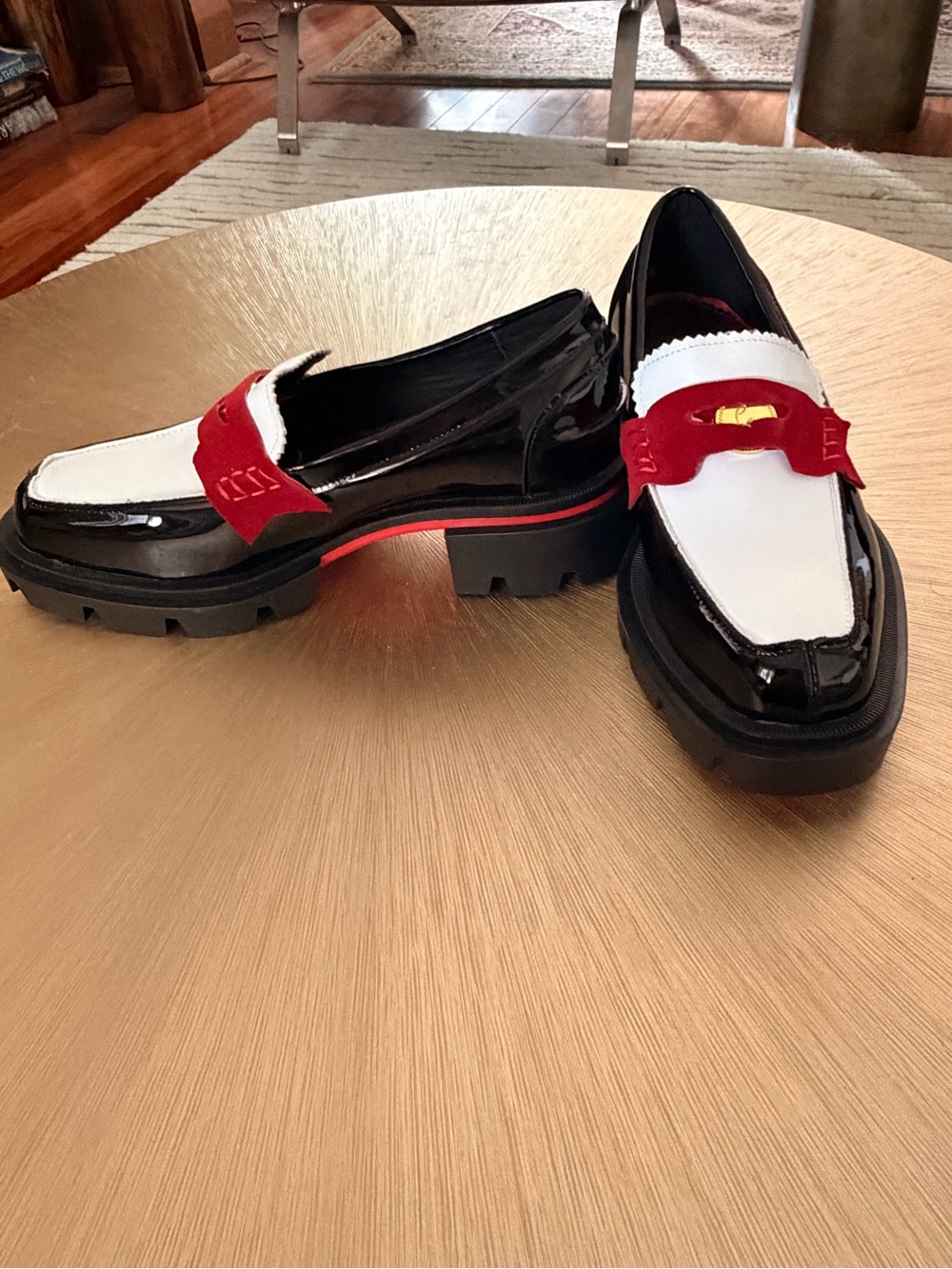 Christian Louboutin Black patent calf leather with red and white highlights.